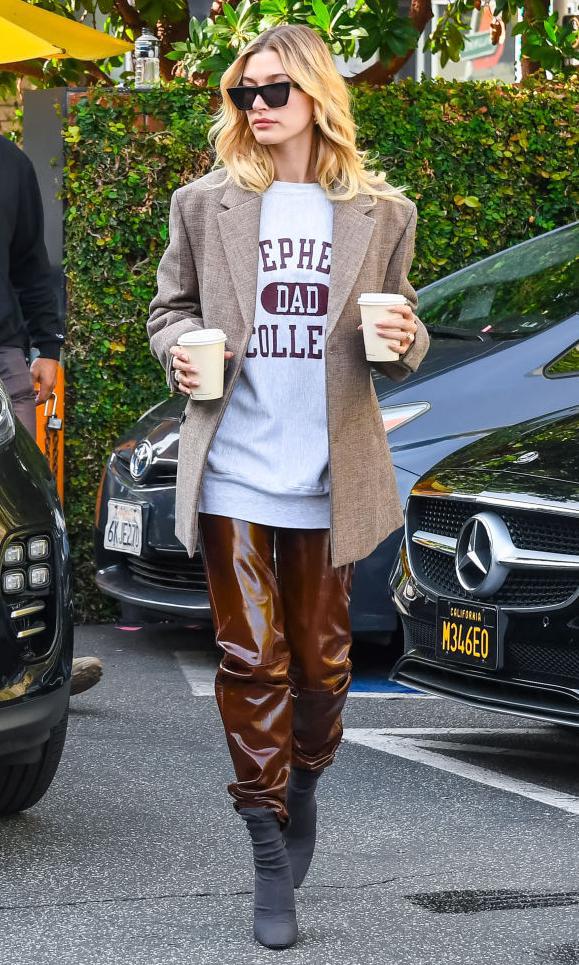 hailey baldwin con pantalones de cuero marron brillante y jacket oversized