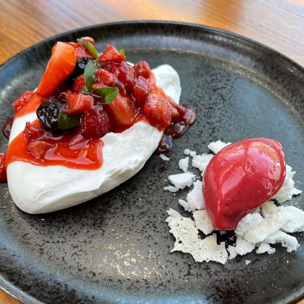 Vegan Pavlova has mixed berries and raspberry sorbet